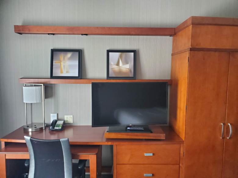 Desk area with chair and tv at Courtyard by Marriott 