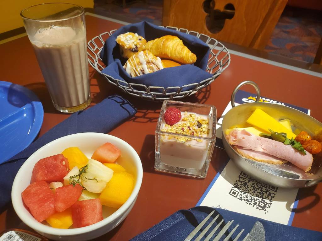 Fruit bowl, bread basket, assorted meats and cheese at Chef Mickey's