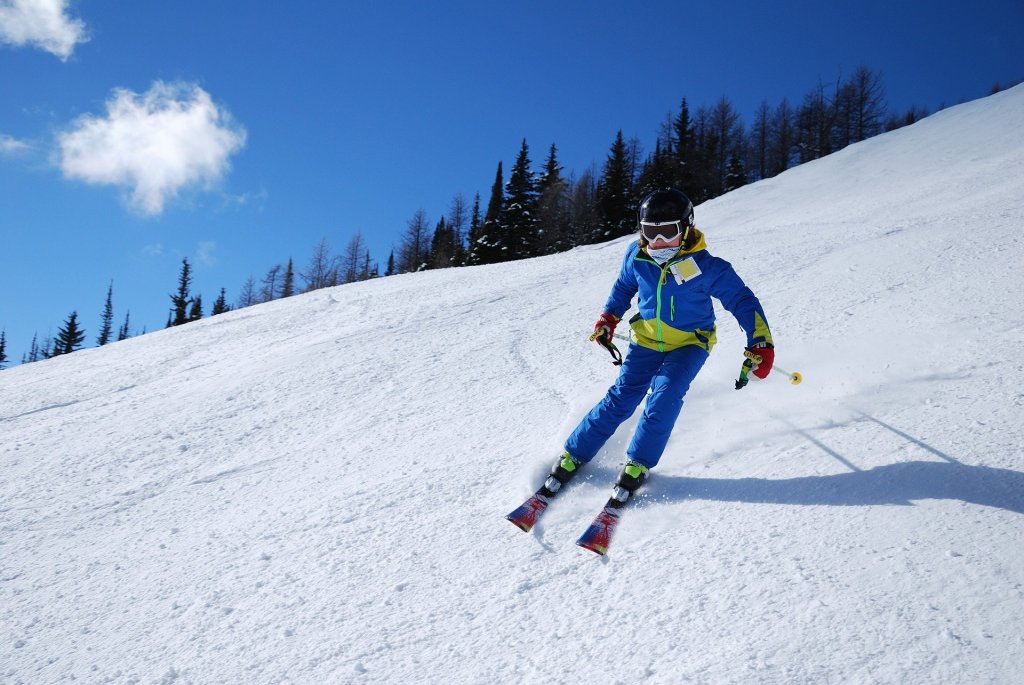Skier skiing down a snow covered mountain 